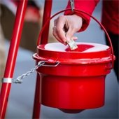 Person putting money into Salvation Army Red Kettle