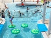 Children playing on the lily pads at the River Springs Water Park
