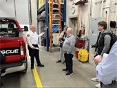 Fire Chief Ed Hoffman (left) shows local media representatives around the 100-plus year old fire station.