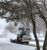 photo of snow being cleared from sidewalk