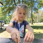 Photo of child playing with dinosaurs