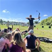 Photo of children watching an archery lesson