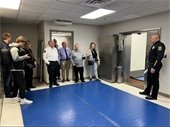 Police Chief Jeff Mundale shows local media representatives a training area that was once a bank vault for the building's previous owner.